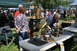 1959 Kenworth W900A - Outdoor event features displays of antique engines and machinery with attendees observing.
