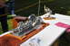 1959 Kenworth W900A - A detailed model steam engine and a separate model propeller are displayed on a table outdoors.