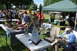1959 Kenworth W900A - A golf cart is visible under a green tent at an outdoor gathering with people and displays.