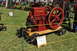 1959 Kenworth W900A - A red Manitoba stationary engine is displayed on a wooden base with wheels at an outdoor event.