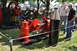 1959 Kenworth W900A - An antique steam engine is displayed outdoors with onlookers observing the machinery.