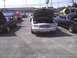 2003 Ford Crown Victoria - A silver 2003 Ford Crown Victoria is parked with its hood open, alongside other vehicles.