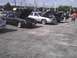 2003 Ford Crown Victoria - Several cars are parked in a lot with their hoods open, possibly at a car show.