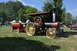 1959 Kenworth W900A - A vintage Russell steam tractor is seen at an outdoor event, emitting smoke from its chimney.