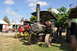 1959 Kenworth W900A - Several vintage steam tractors are displayed on a grassy field under a partly cloudy sky.