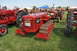 1959 Kenworth W900A - A red International crawler tractor is displayed on a grassy field with other farm equipment.
