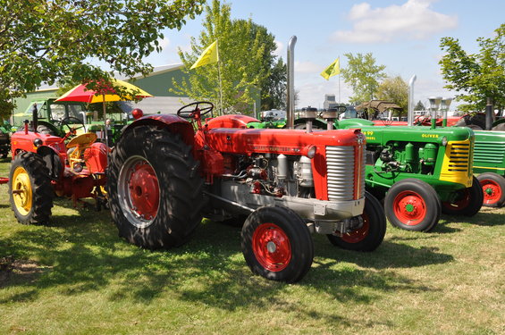 Red tractor with silver grille and large rear wheels