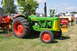 1959 Kenworth W900A - An Oliver Super 99 Diesel tractor is displayed outdoors at an event with other farm equipment.