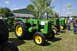 1959 Kenworth W900A - A lineup of vintage John Deere tractors displayed outdoors on a sunny day.