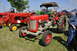 1959 Kenworth W900A - Several tractors are displayed on a grassy field under a clear sky.