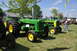 1959 Kenworth W900A - Two green John Deere tractors are parked on a grassy field under a blue sky.