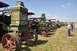 1959 Kenworth W900A - Antique steam tractors displayed at an outdoor event under a partly cloudy sky.
