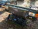 1988 Ford Bronco - Disassembled front end components of a Ford truck, including the grille and headlight assembly.