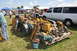 1959 Kenworth W900A - A trailer overflowing with various mechanical parts sits on a grassy field at an outdoor event.