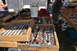 1959 Kenworth W900A - A variety of tools and parts are displayed for sale at an outdoor market.