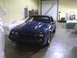 2003 Ford Crown Victoria - This blue coupe features a prominent hood scoop and is parked indoors.