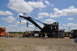 1959 Kenworth W900A - A large black railroad crane is displayed outdoors under a cloudy sky.