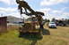 1959 Kenworth W900A - A weathered GMC truck with attached drilling equipment sits in a field next to other vehicles.