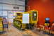1959 Kenworth W900A - A yellow Caterpillar diesel crawler tractor is displayed indoors with an information board and chairs.