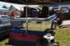 1959 Kenworth W900A - Various truck parts, including seats and a tailgate, are laid out for sale under a canopy.