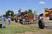 1959 Kenworth W900A - Several pieces of heavy equipment are on display at an outdoor event, under a clear blue sky.