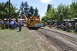 1959 Kenworth W900A - Yellow logging equipment with "PACIFIC NORTHWEST LOGGING MUSEUM" sign is displayed at an outdoor event.