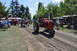 1959 Kenworth W900A - Two vintage Farmall tractors are driven in a parade at an outdoor event.