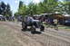 1959 Kenworth W900A - A man drives a gray tractor with the number 145 on its grille during an event.