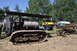 1959 Kenworth W900A - A vintage Caterpillar tractor, identified by the '1918 HOLT' marking on its tank, is displayed outdoors with other vehicles and equipment.