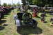 1959 Kenworth W900A - A collection of vintage engines and tractors are displayed outdoors on a sunny day.