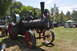 1959 Kenworth W900A - A vintage CASE steam traction engine is displayed outdoors at an event, with tents and trees in the background.