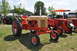 1959 Kenworth W900A - A vintage Case tractor is displayed at an outdoor event, alongside other agricultural machinery.