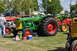 1959 Kenworth W900A - A green Oliver Super 99 Diesel tractor is displayed at an outdoor event with other farm equipment.