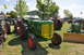 1959 Kenworth W900A - An Oliver 99 tractor is displayed outdoors with other farm equipment.