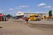 1959 Kenworth W900A - A yellow school bus is parked outside the Antique Caterpillar Machinery Museum, with various pieces of construction equipment visible.