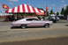 1959 Kenworth W900A - A pink 1966 Dodge Charger is seen from the side at an outdoor gathering.