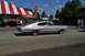 1959 Kenworth W900A - A pink 1966 Dodge Charger is seen from the side at an outdoor event.