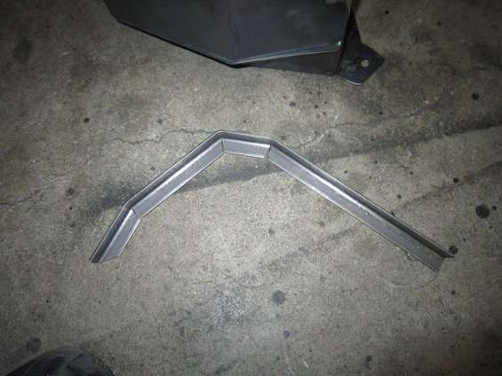 Metal bracket with V-shaped bend on concrete floor