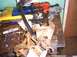 1991 Ford Crown Victoria - Workbench cluttered with tools and a disassembled pedal assembly.