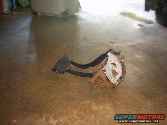 Car brake and accelerator pedals assembly on a concrete floor