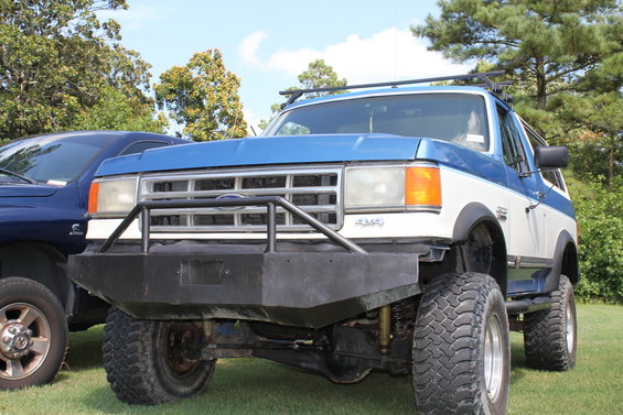 Blue and white 1994 Ford Bronco front view with aftermarket bumper and roof rack