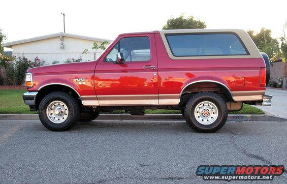 Red 1994 Ford Bronco side view with tan top