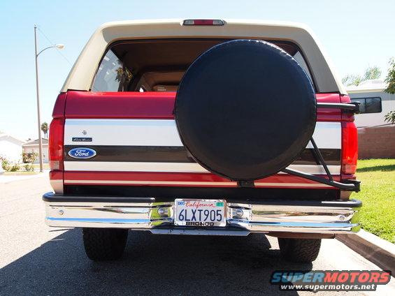 Red and tan 1994 Ford Bronco rear with spare tire on California license plate 6LXT905