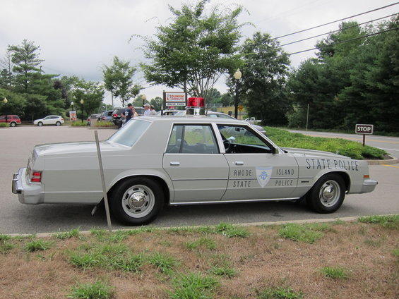 1979 Plymouth Gran Fury police car with "RHODE ISLAND STATE POLICE" text on door