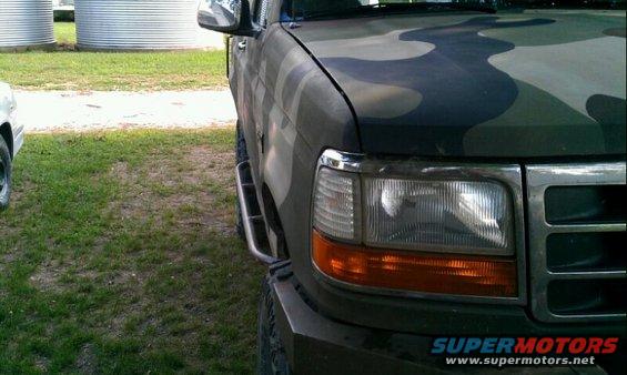 Camouflaged Ford truck front fender and headlight with side step