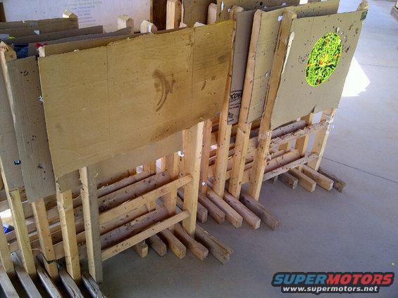 Cardboard shooting targets on wooden stands