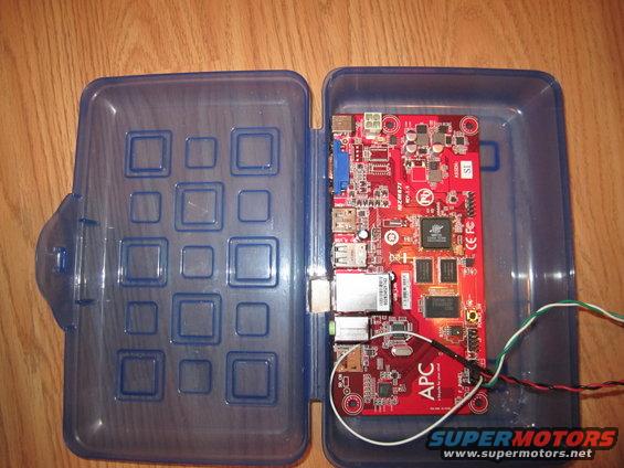 APC circuit board with ports and wires inside a blue plastic case