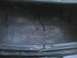 2003 Ford Crown Victoria - The interior of a car's trunk shows a worn carpet and some loose electrical wires.