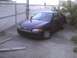 2003 Ford Crown Victoria - This black coupe is parked on concrete, seen from a 3/4 front angle.