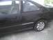 2003 Ford Crown Victoria - Side profile of a black coupe, revealing the interior and exterior details.